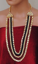 Goldpolish mehroon, green and white kundan set