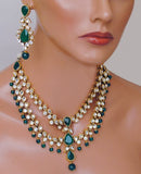Goldpolish emerald green and white kundan set